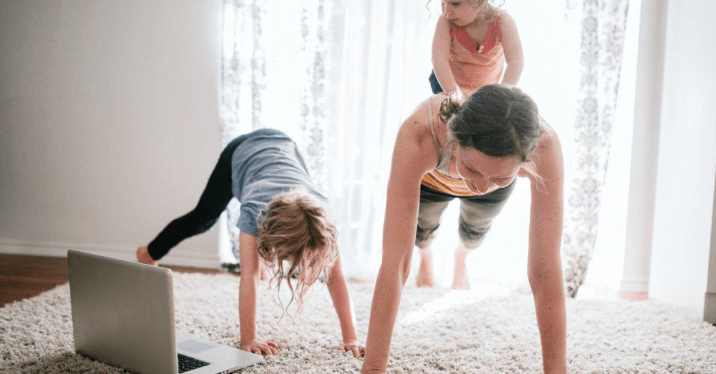 female working out at home with kids