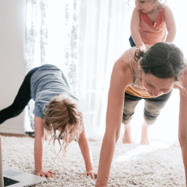 female working out at home with kids