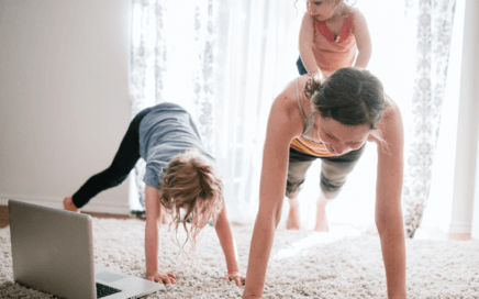 female working out at home with kids