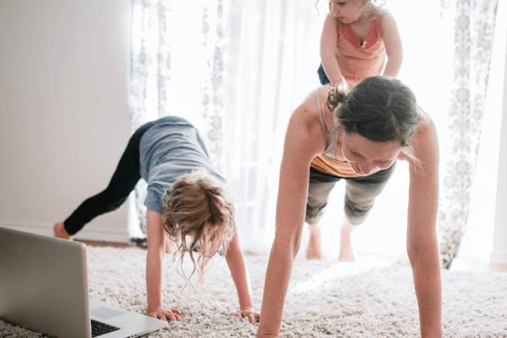 female working out at home with kids