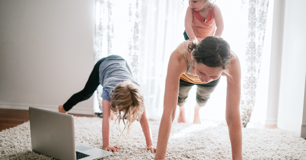 female working out at home with kids